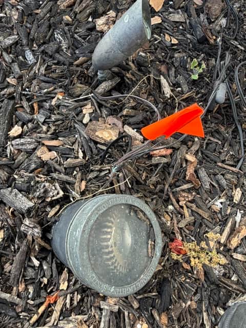 Corroded landscape lighting fixture with disconnected wiring found during inspection