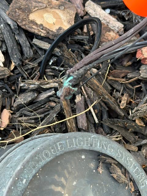 Exposed unsealed wire splice with no waterproofing found in a landscape lighting system