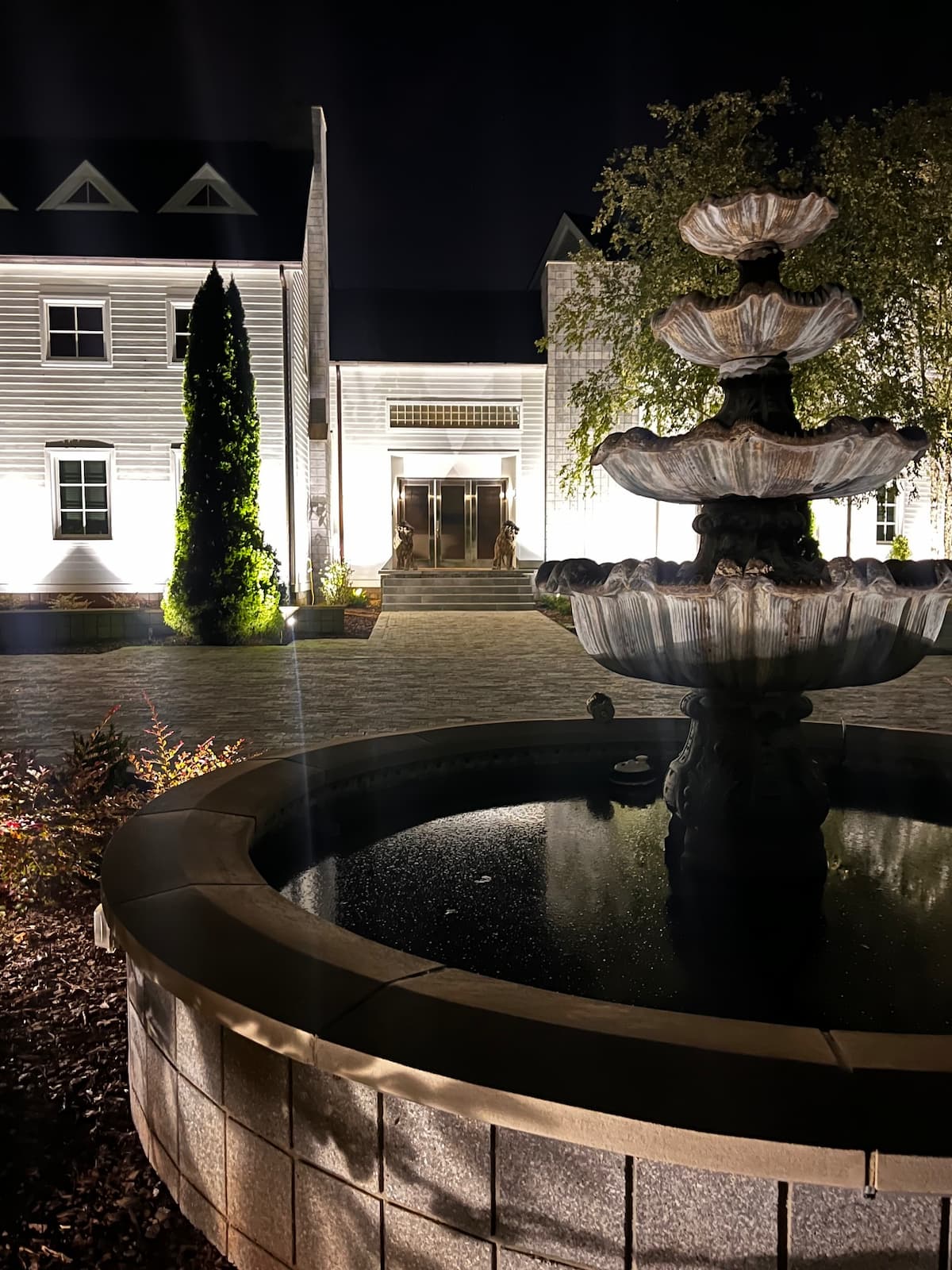 Tiered fountain and estate uplighting installation by Luna Vista Exterior Lighting
