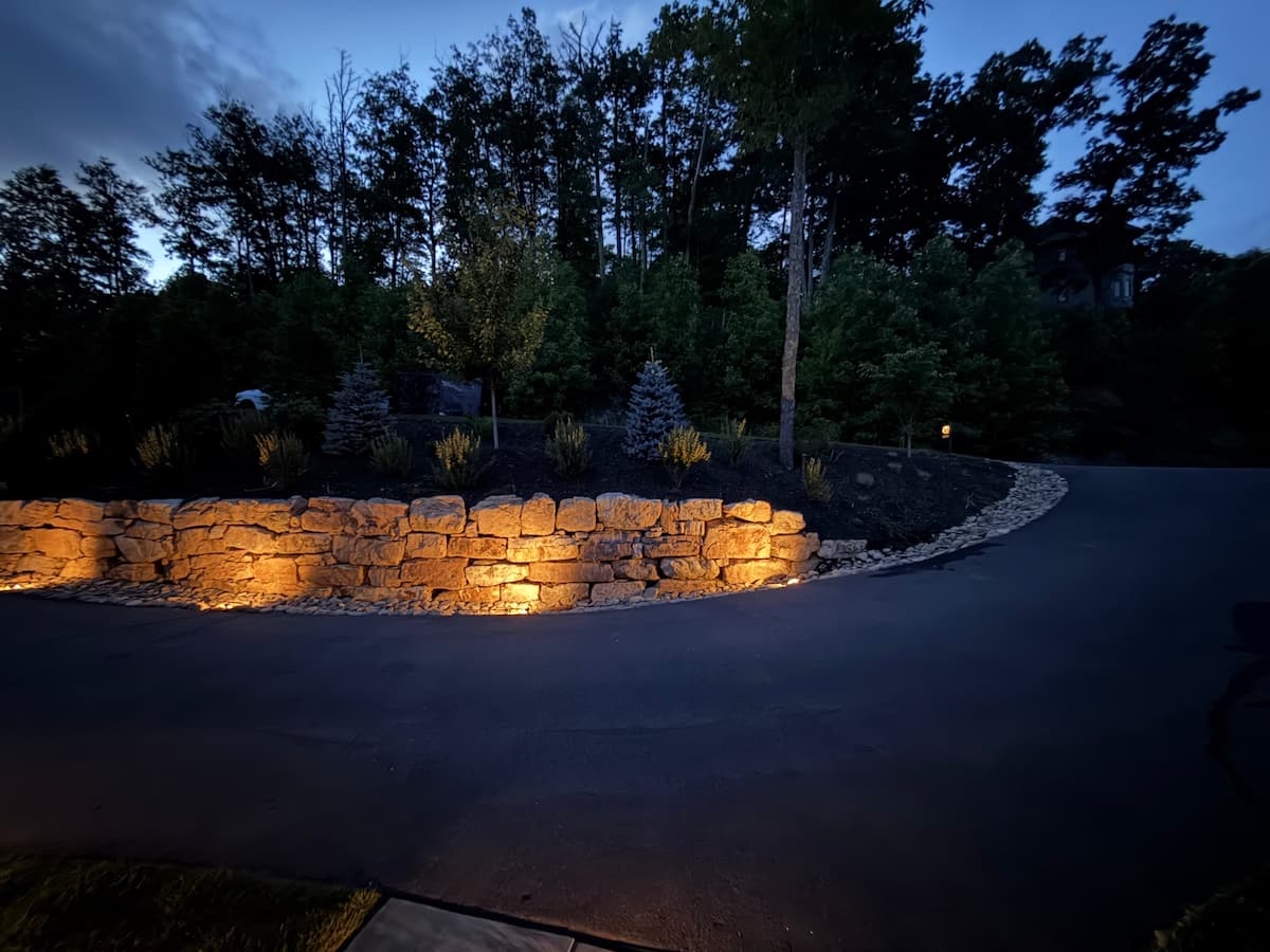 Natural stone retaining wall accent lighting installation by Luna Vista Exterior Lighting