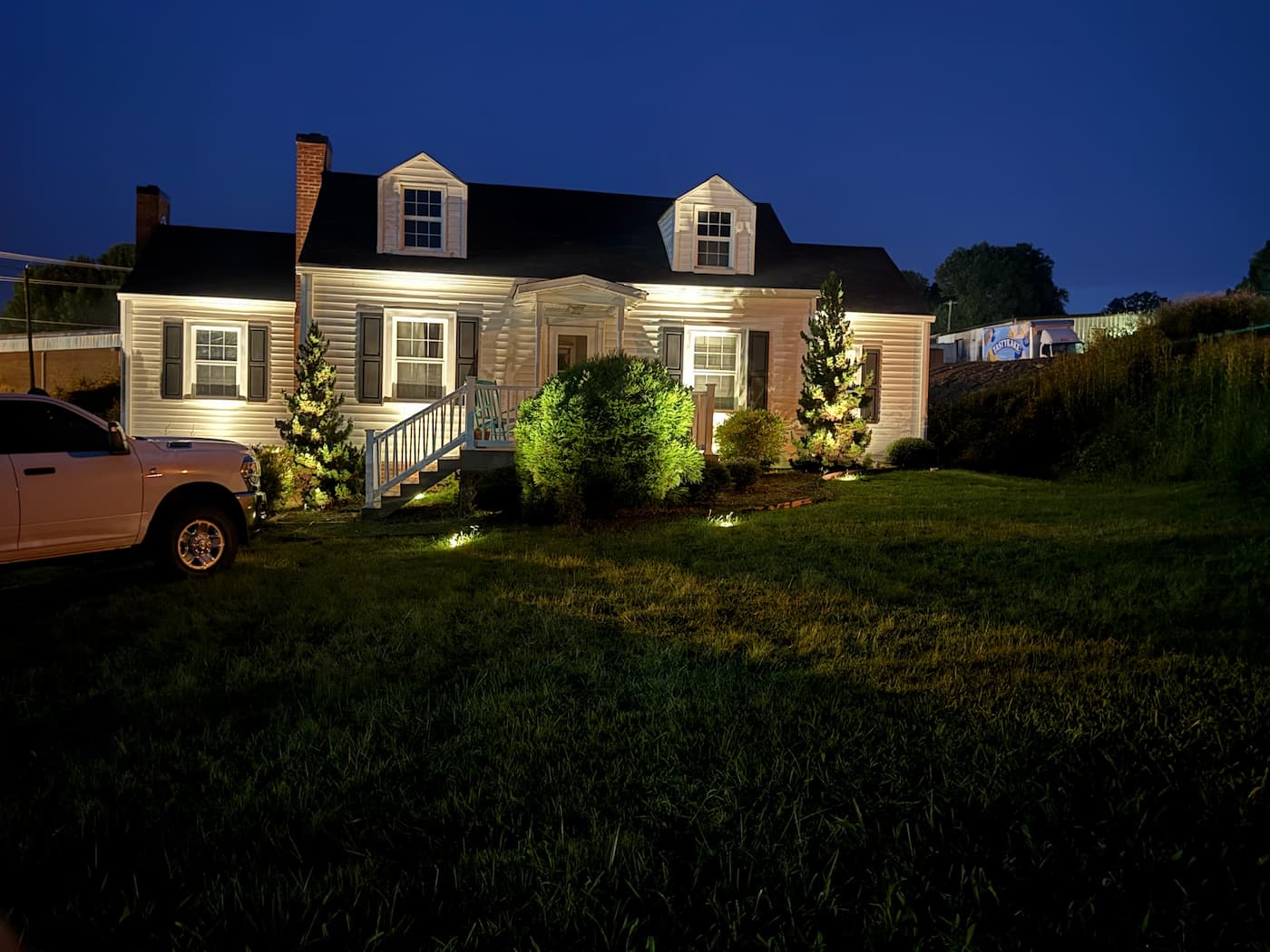 Nighttime lighting demonstration on a cape cod home in Wilkesboro NC by Luna Vista Exterior Lighting
